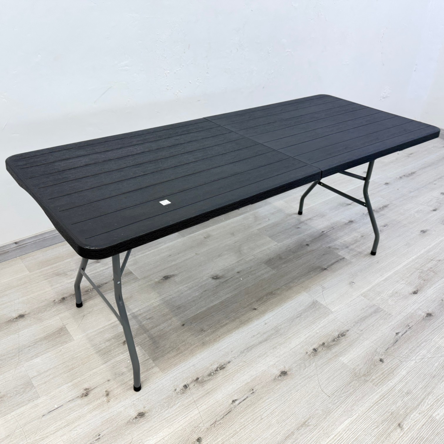 Summit 1.8m black outdoor folding table with stone-finish plastic top and metal legs
